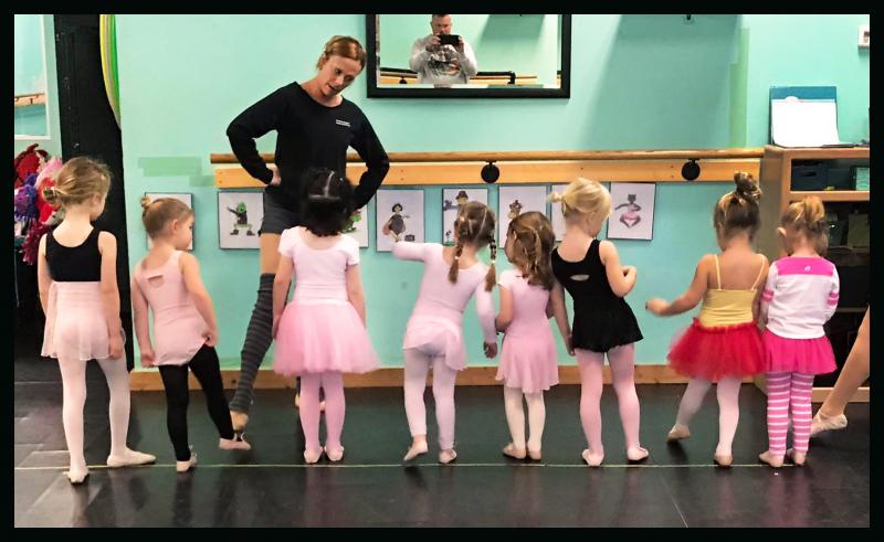 Professional dance teachers lead classes for preschool dance students. 